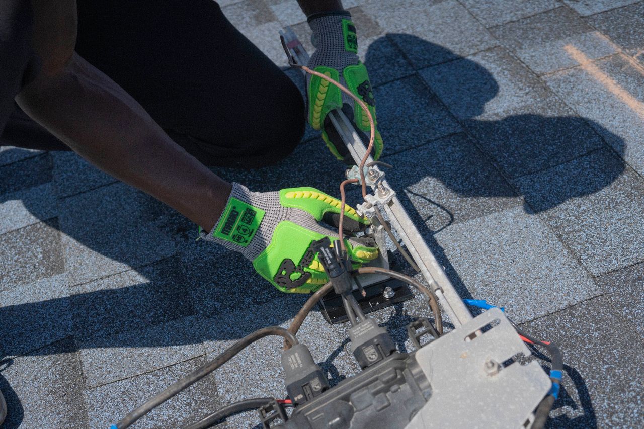 The Art of Drawing Readers In: Your attractive post title goes here Close-up of a technician working on solar panel installation with green gloves in Tampa, Florida.