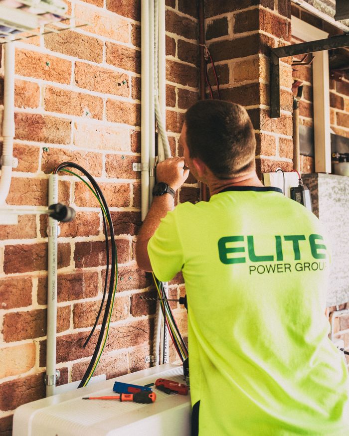 Mastering the First Impression: Your intriguing post title goes here Electrician working on solar energy wiring installation, ensuring efficient electrical system indoors.