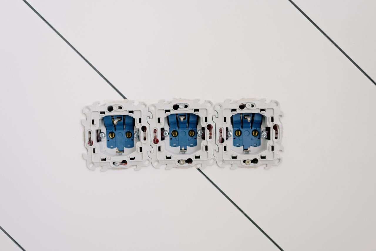 our-mission Power sockets with various connectors and bolts on wall in room at home